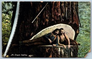 Postcard Oregon c1910s An Oregon Sapling 2 Men Lying in Cut Large Saw