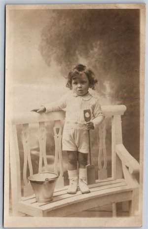 Postcard RPPC c1920 Studio Photo of Child with Props by C. Howell & Son