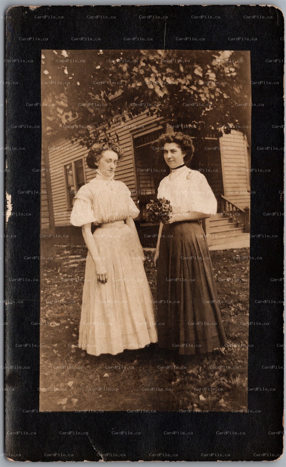 Postcard RPPC c1910s Two Women with Flowers Edwardian Era Fashion House Backdrop