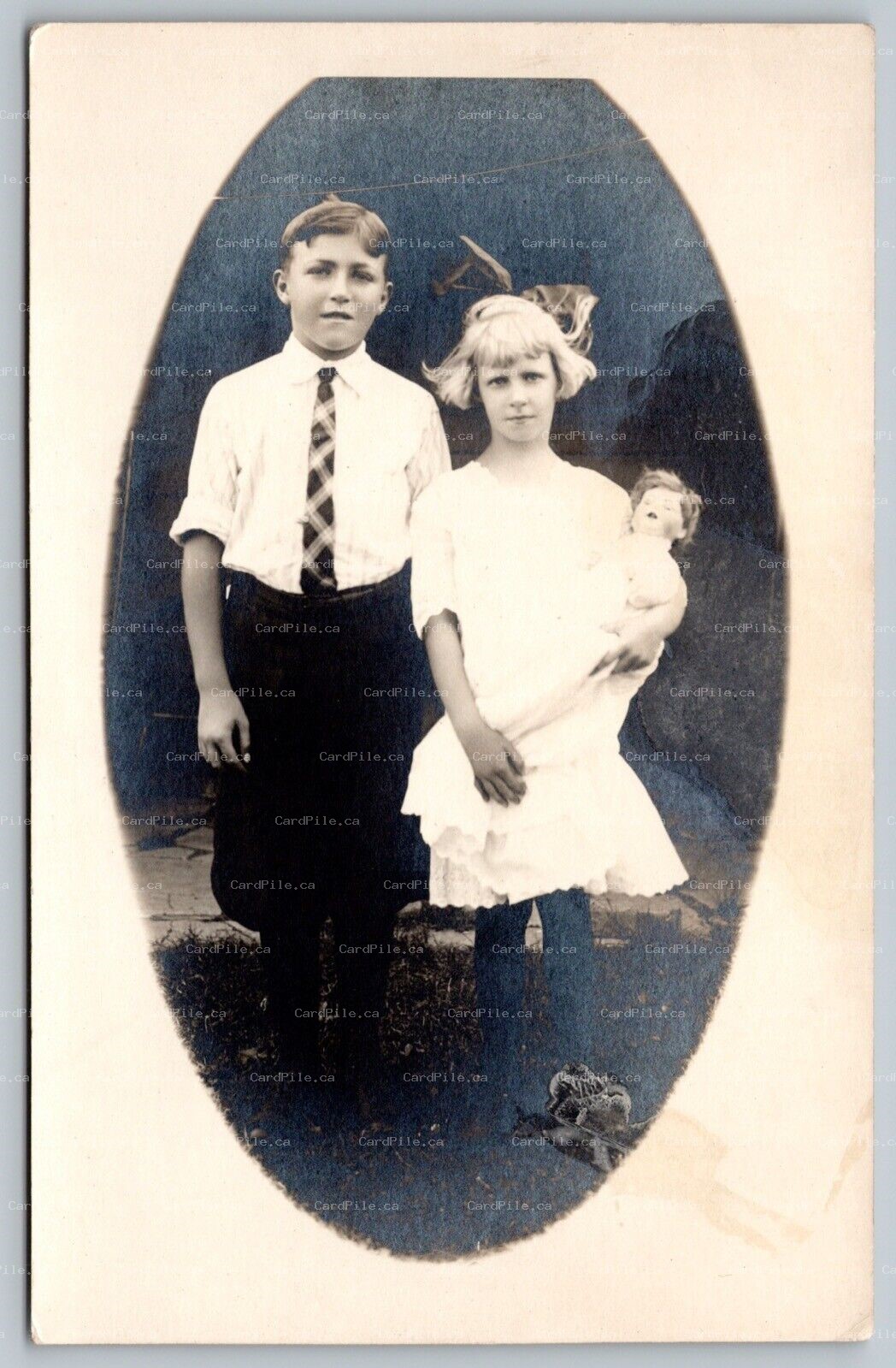 Postcard RPPC c1910s Photograph of two Kids Brother Sister Holding Doll