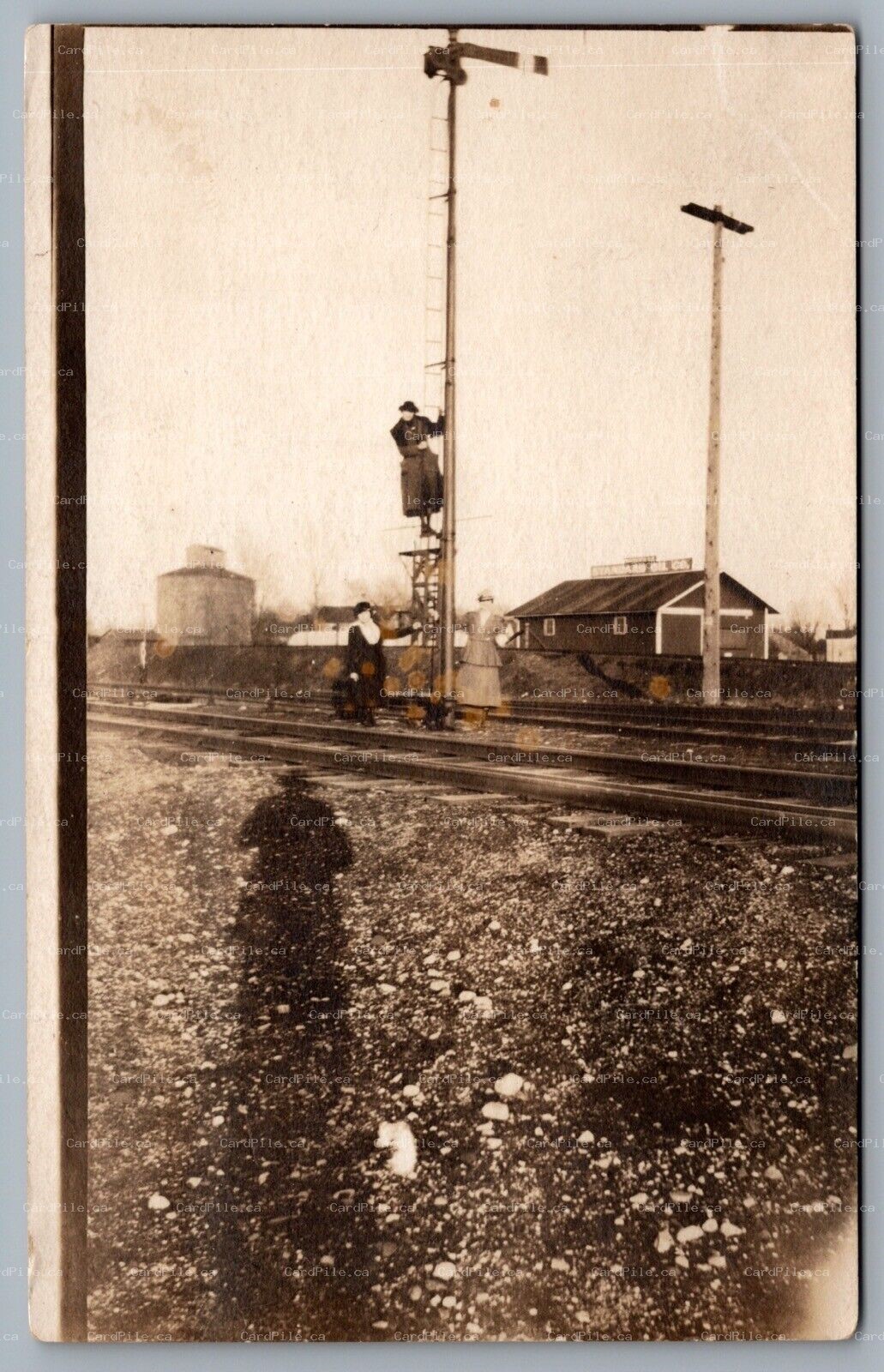 Postcard RPPC c1918 Ladies On Tracks Climbing Signal Tower Standard Oil Co. Sign
