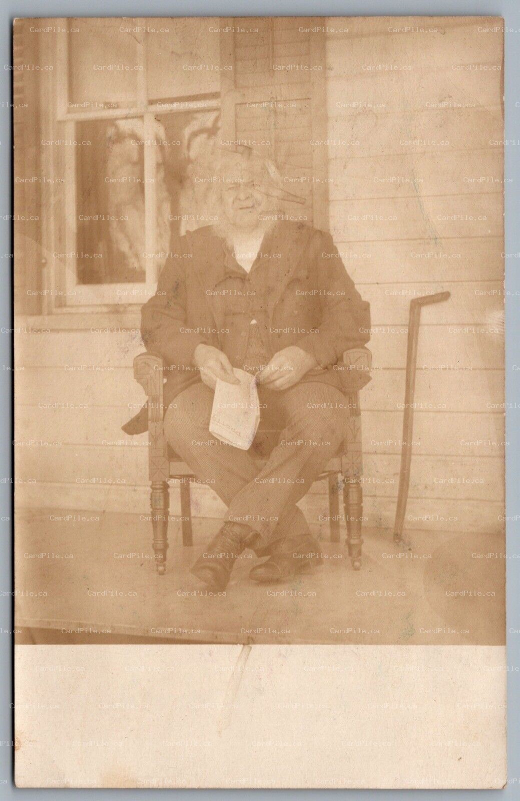 Postcard RPPC c1905 United States Elderly Man Sitting On Porch With Paper Pratts