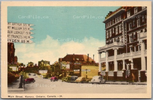 Postcard Kenora Ontario c1940s Main Street Signpost Old Cars Safeway Hotel